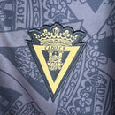 Camisa Cadiz III 23/24 - Torcedor Macron Masculina - Preta com detalhes em dourado